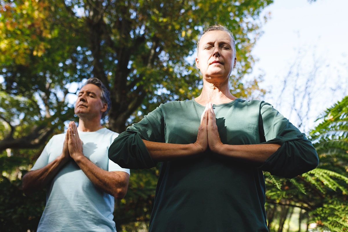 Older couple using yoga to maximize hormone treatments